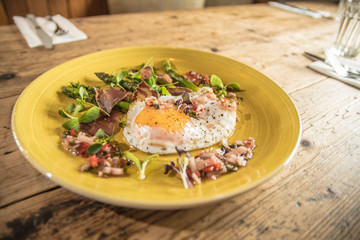 Starter fried egg with micro greens and asparagus bistro pub starter meal