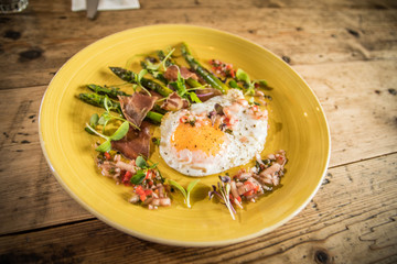Starter fried egg with micro greens and asparagus bistro pub starter meal