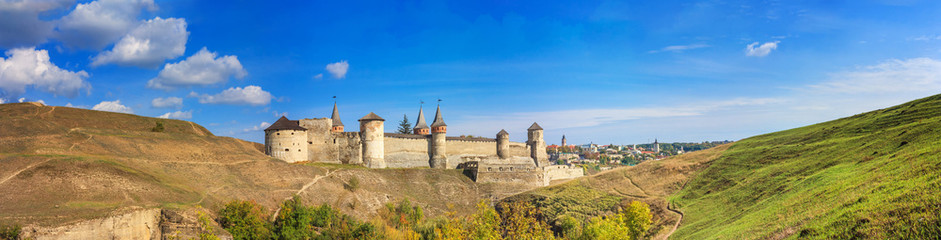 Autumn landscape, panorama, banner - view of a medieval fortified castle on a hill, the town of...