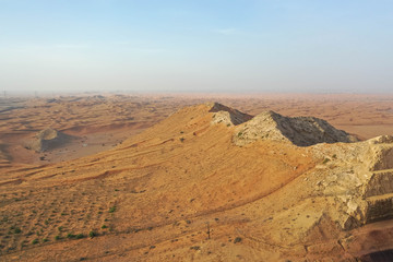 Fototapeta na wymiar Drone view of Dry Desert in Dubai with Sand Ripples, High Dune Desert in United Arab Emirates 