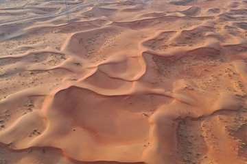 Fototapeta na wymiar Drone view of Dry Desert in Dubai with Sand Ripples, High Dune Desert in United Arab Emirates 