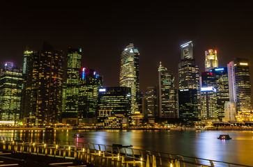 Fototapeta na wymiar Metropolitan Singapore Skyline Illuminates at Night on Marina Bay