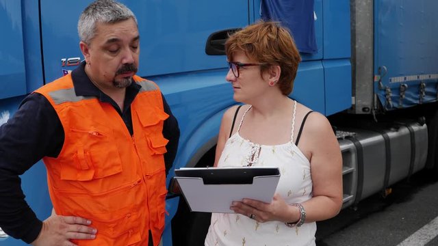 Truck driver receiving instructions from a woman.