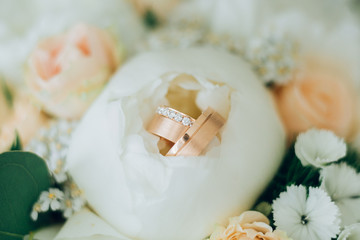 wedding rings with diamonds in peonies