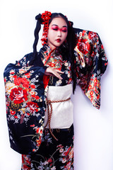 young pretty geisha in black kimono with sakura, asian ethno closeup on white background isolated