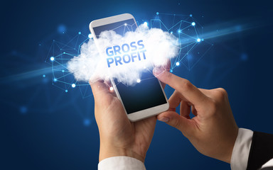 Female hand touching smartphone with GROSS PROFIT inscription, cloud business concept