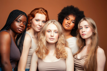 Obraz premium young pretty caucasian, afro, scandinavian woman posing cheerful together on brown background, lifestyle diverse nationality people concept
