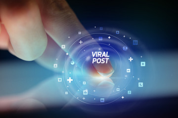 Finger touching tablet with social media icons and VIRAL POST