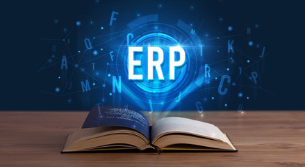 ERP inscription coming out from an open book, digital technology concept