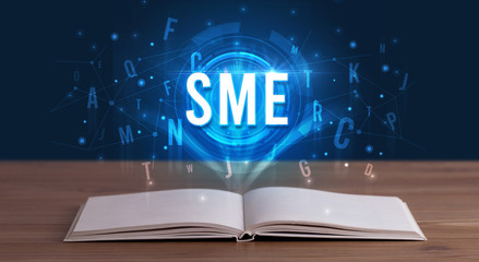 SME inscription coming out from an open book, digital technology concept