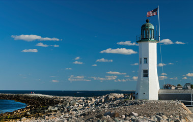 Fototapeta na wymiar Scituate Harbor Lighthouse on Rocky Breakwater in Massachusetts