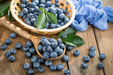 Blueberries in a plate and pancakes, on an old background.