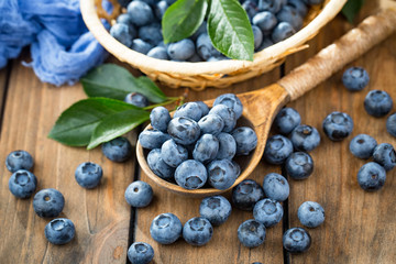 Blueberries in a plate and pancakes, on an old background.
