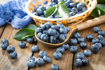 Blueberries in a plate and pancakes, on an old background.
