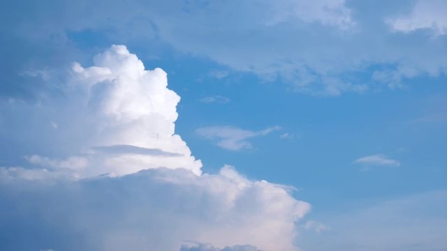Massive clouds - cumulus congestus or towering cumulus - forming in the blue sky