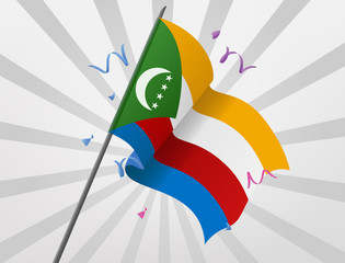 The celebratory flag of Comoros is flying at height