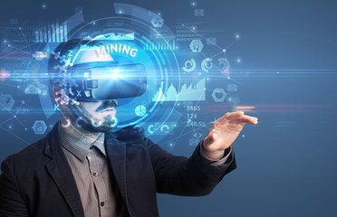 Businessman looking through Virtual Reality glasses with MINING inscription, innovative technology concept