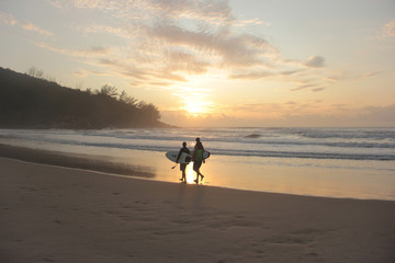 
two surfers on the beach