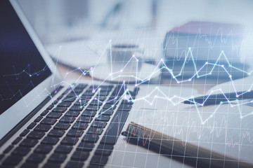 Double exposure of financial chart drawing and desktop with coffee and items on table background. Concept of forex market trading