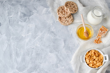 Oatmeal with honey and milk, from the left there is a place for the text. Healthy diet. Flat lay.
