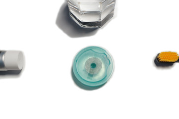 Naklejka premium toothbrush, dental floss, paste with glass on white background