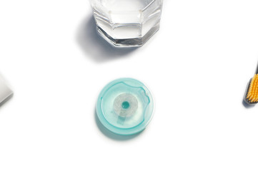 toothbrush, dental floss, paste with glass on white background