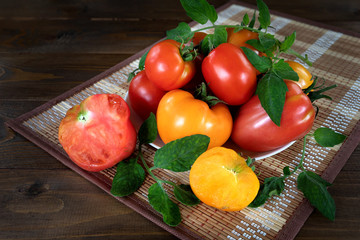 Still life of red and yellow tomatoes on a wooden background