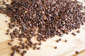 Coffee grains on wooden table, with natural light