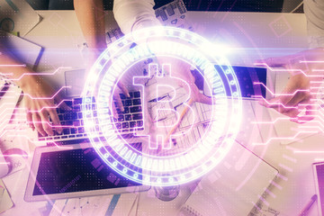 Double exposure of man and woman working together and crypto theme hologram drawing. Computer background. Blockchain concept. Top View.