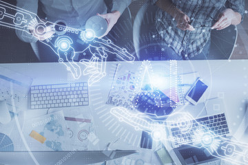 Double exposure of man and woman working together and data theme hologram drawing. Computer background. Top View.