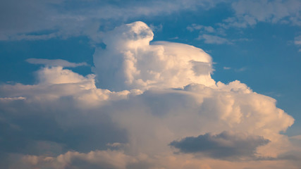 Massive rain cloud - cumulus congestus or towering cumulus - forming in the blue sky