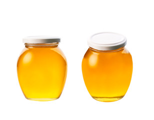 glass jar of honey isolated on white background.