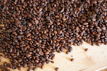 Coffee grains on wooden table, with natural light