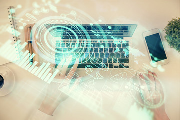 Double exposure of woman hands working on computer and financial theme hologram drawing. Top View. Business concept.