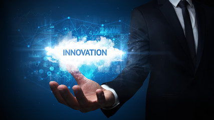Hand of Businessman holding INNOVATION inscription, successful business concept