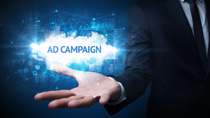 Fototapeta premium Hand of Businessman holding AD CAMPAIGN inscription, successful business concept