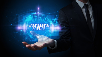 Man hand holding ENGINEERING SCIENCE inscription, technology concept