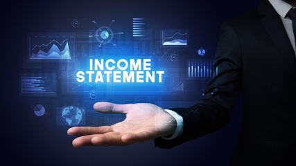 Hand of Businessman holding INCOME STATEMENT inscription, business success concept