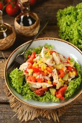 Salad with chicken, cherry tomatoes, avocado, corn, onion, bell pepper and lettuce. Healthly food.