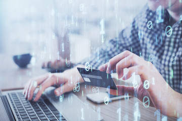 Fototapeta premium Double exposure of man hands holding a credit card and data theme drawing. E-commerce and technology concept.