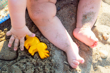 Kid on the beach with toys
