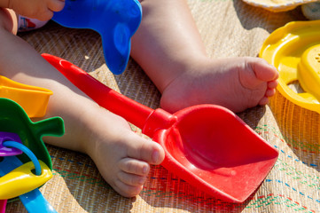 Kid on the beach with toys
