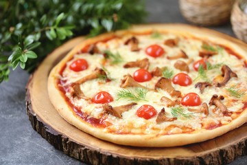 Organic pizza on rice dough with chanterelle mushrooms, cherry tomatoes and mozzarella.