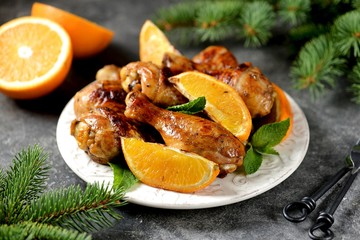 Chicken drumsticks baked with orange and mint. Organic food.