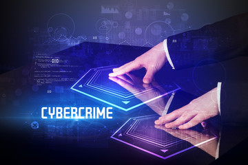 Hand touching digital table with CYBERCRIME inscription, new age security concept