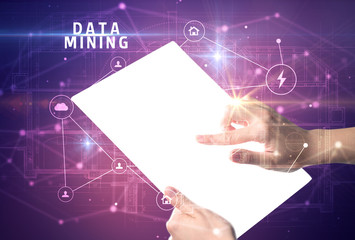 Holding futuristic tablet with DATA MINING inscription, cyber security concept