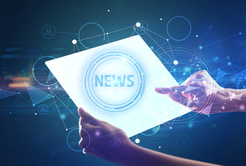 Hand holdig futuristic tablet with NEWS inscription, modern technology concept