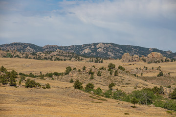 landscape with trees mountains and clouds