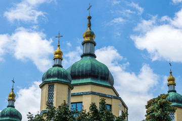 Onion shape domes of orthodox church building against the blue sky. Ukrainian Catholic Church of Holy Protection of the Mother of God