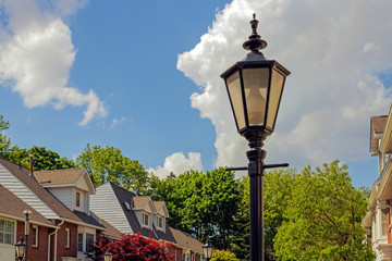 A row of private homes community with an old fashioned street light in the foreground